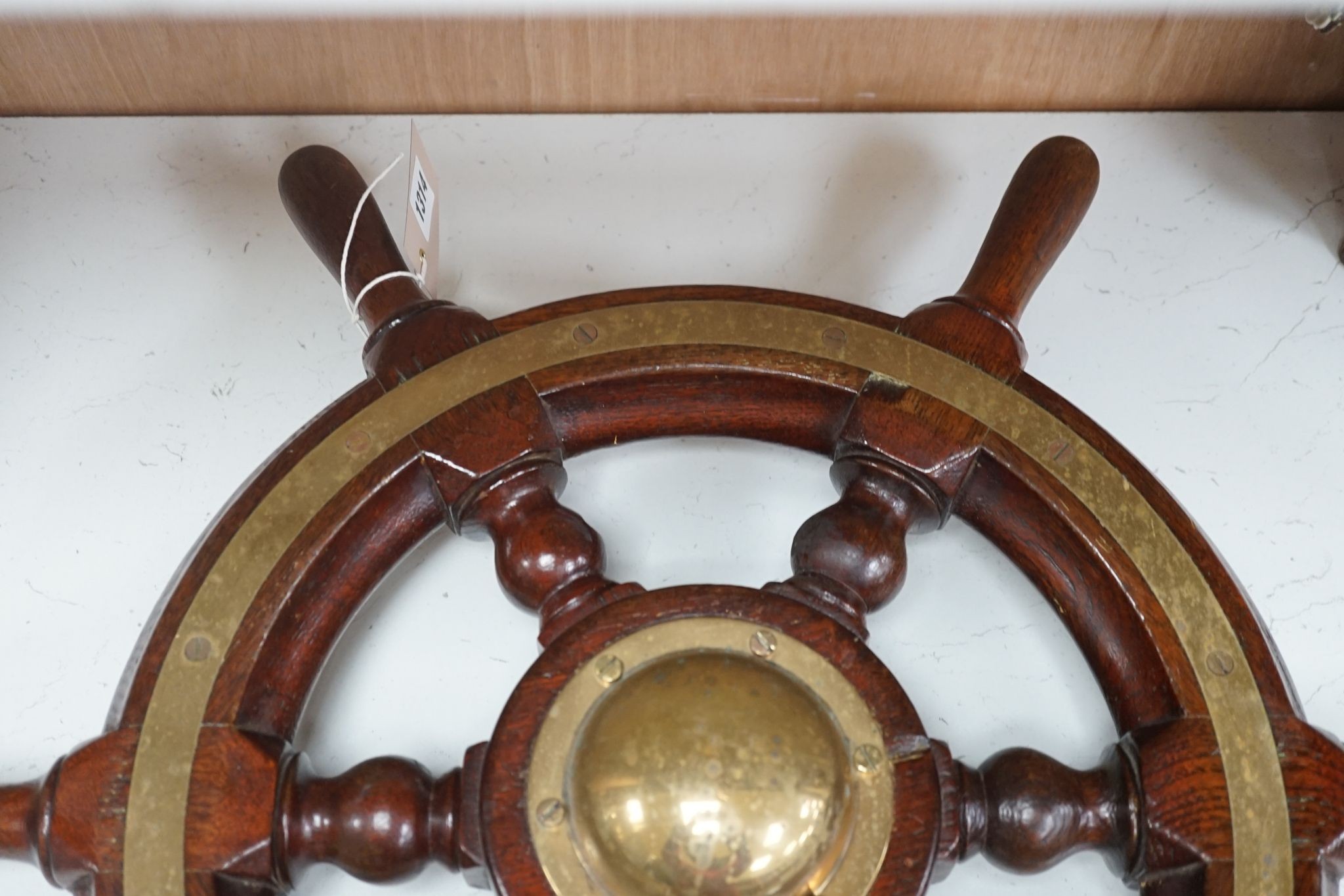 An early 20th century teak and brass mounted ship’s wheel 64cm